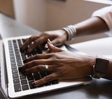 woman hands typing on laptop keyboard