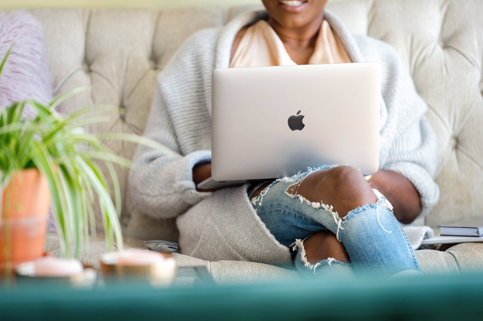 woman sitting on couch with laptop